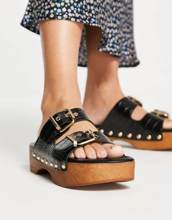 https://images.styletyx.com/images/raid-hellena-buckle-mule-clog-sandals-in-black-croc-raid-1735167_3.webp