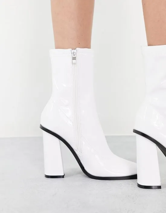 https://images.styletyx.com/images/raid-saylor-block-heel-sock-boot-in-white-patent-raid-2772435_3.webp