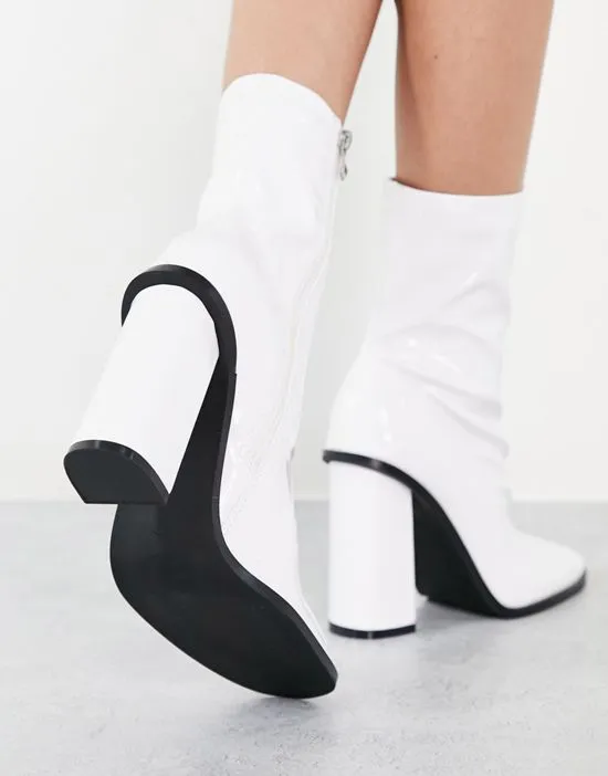 https://images.styletyx.com/images/raid-saylor-block-heel-sock-boot-in-white-patent-raid-2772435_4.webp