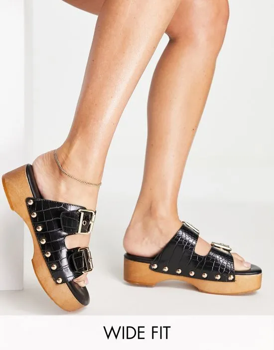 https://images.styletyx.com/images/raid-wide-fit-hellena-buckle-mule-clog-sandals-in-black-croc-raid-wide-fit-2788752_1.webp