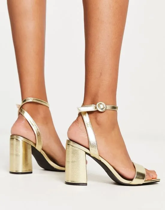 https://images.styletyx.com/images/raid-wide-fit-wink-block-heel-sandals-in-gold-raid-wide-fit-12909917_2.webp