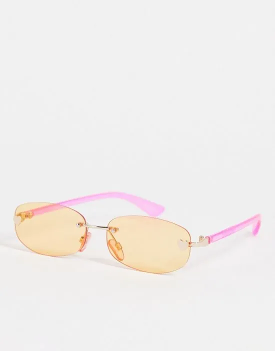 https://images.styletyx.com/images/rimless-narrow-sunglasses-in-pink-with-orange-tinted-lens-skinnydip-13293440_1.webp