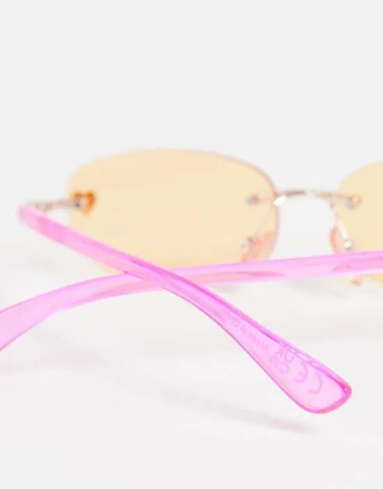 https://images.styletyx.com/images/rimless-narrow-sunglasses-in-pink-with-orange-tinted-lens-skinnydip-13293440_3.webp
