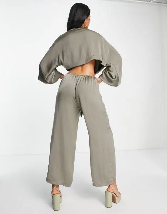 https://images.styletyx.com/images/satin-tie-front-open-back-jumpsuit-in-khaki-sndys-2341503_2.webp