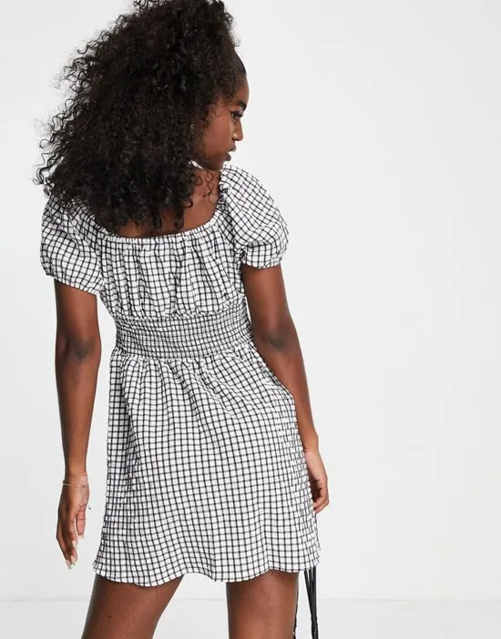 https://images.styletyx.com/images/shirred-mini-milkmaid-tea-dress-in-gingham-wednesday-s-girl-1829990_3.webp
