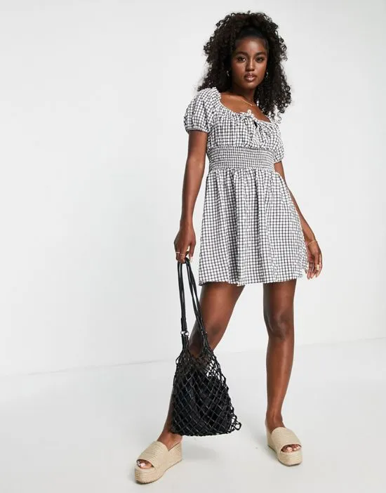 https://images.styletyx.com/images/shirred-mini-milkmaid-tea-dress-in-gingham-wednesday-s-girl-1829990_4.webp