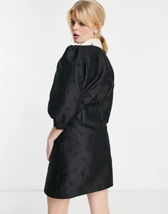 https://images.styletyx.com/images/sister-jane-mini-button-up-dress-with-contrast-collar-in-black-bow-jacquard-sister-jane-12910428_2.webp