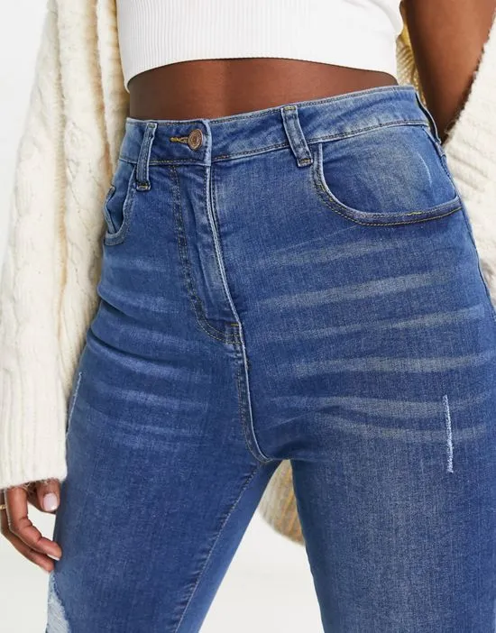 https://images.styletyx.com/images/skinny-jeans-with-rips-in-mid-wash-blue-parisian-13285872_2.webp