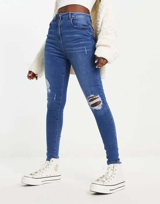 https://images.styletyx.com/images/skinny-jeans-with-rips-in-mid-wash-blue-parisian-13285872_3.webp