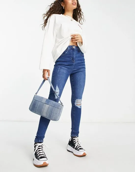 https://images.styletyx.com/images/skinny-jeans-with-rips-in-mid-wash-blue-parisian-petite-13285863_4.webp