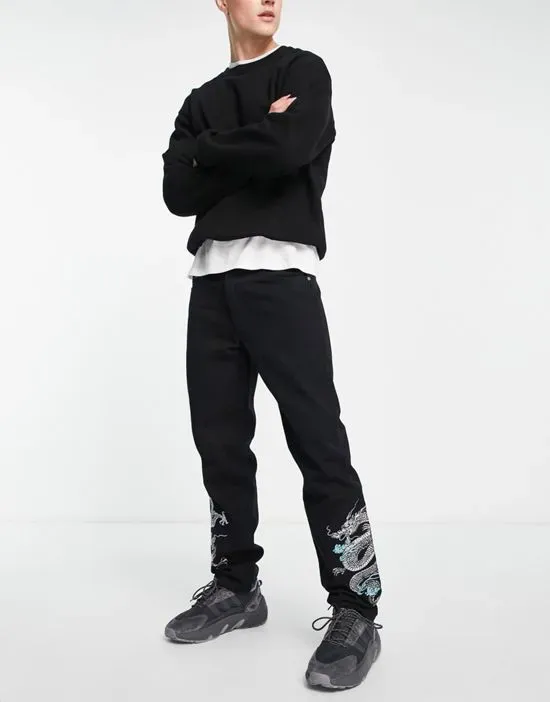 https://images.styletyx.com/images/straight-leg-denim-jeans-in-black-with-dragon-embroidery-liquor-n-poker-13554230_2.webp