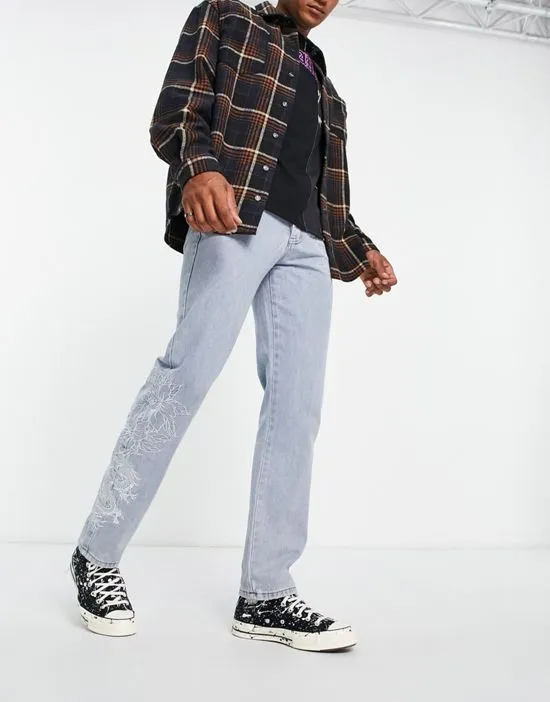 https://images.styletyx.com/images/straight-leg-denim-jeans-in-midwash-blue-with-dragon-and-floral-embroidery-liquor-n-poker-2951502_3.webp