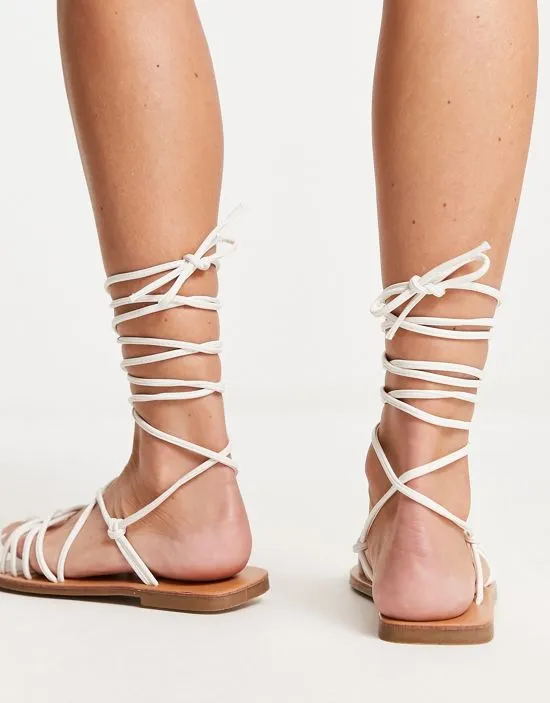 https://images.styletyx.com/images/strappy-tie-leg-flat-sandals-in-white-london-rebel-wide-fit-13315905_3.webp