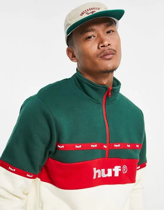 https://images.styletyx.com/images/taped-1-4-zip-sweatshirt-in-off-white-and-green-huf-3076770_2.webp