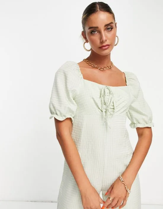 https://images.styletyx.com/images/textured-jumpsuit-with-tie-detail-in-green-gingham-vila-2265095_3.webp