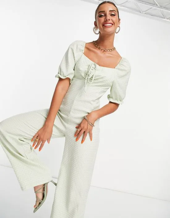 https://images.styletyx.com/images/textured-jumpsuit-with-tie-detail-in-green-gingham-vila-2265095_4.webp