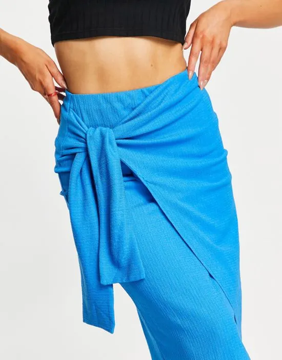 https://images.styletyx.com/images/textured-knot-wrap-midi-skirt-in-blue-stradivarius-2031671_3.webp