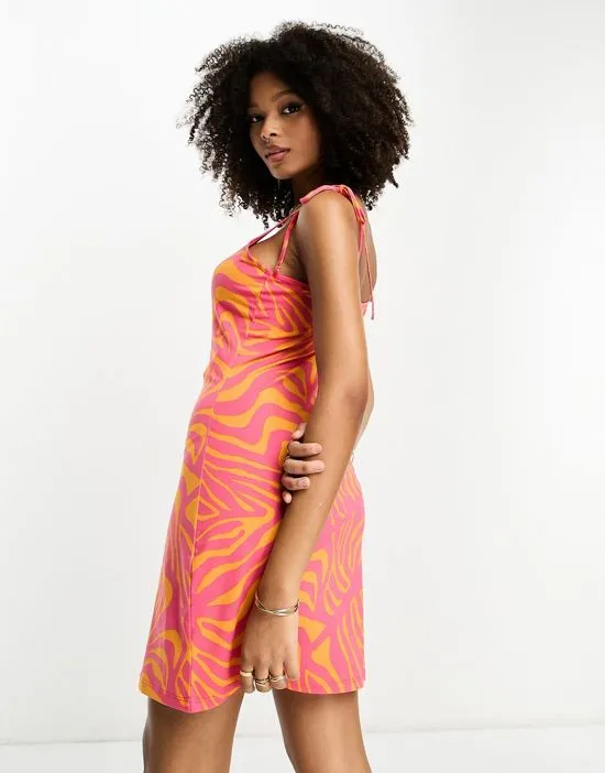 https://images.styletyx.com/images/tie-strap-cami-mini-dress-in-pink-and-orange-animal-print-vila-1222618987_2.webp