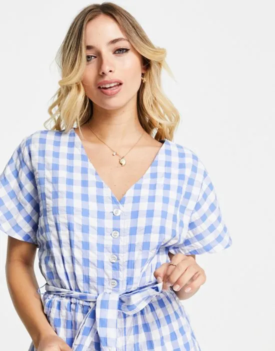 https://images.styletyx.com/images/tie-waist-seersucker-jumpsuit-in-blue-gingham-monki-2788748_3.webp