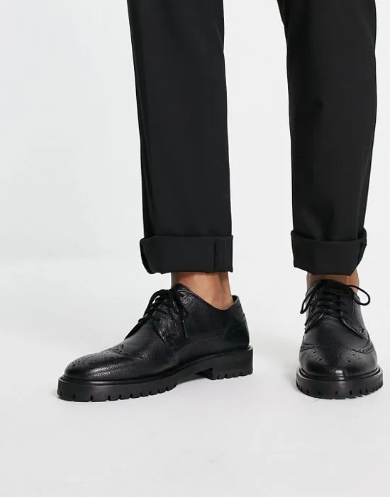 https://images.styletyx.com/images/walk-london-james-chunky-brogues-in-black-leather-walk-london-13663401_1.webp