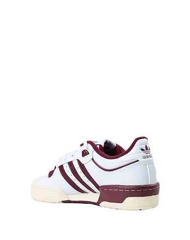 https://images.styletyx.com/images/white-leather-sneakers-rivalry-low-86-w-shoes-adidas-13139501_3.webp