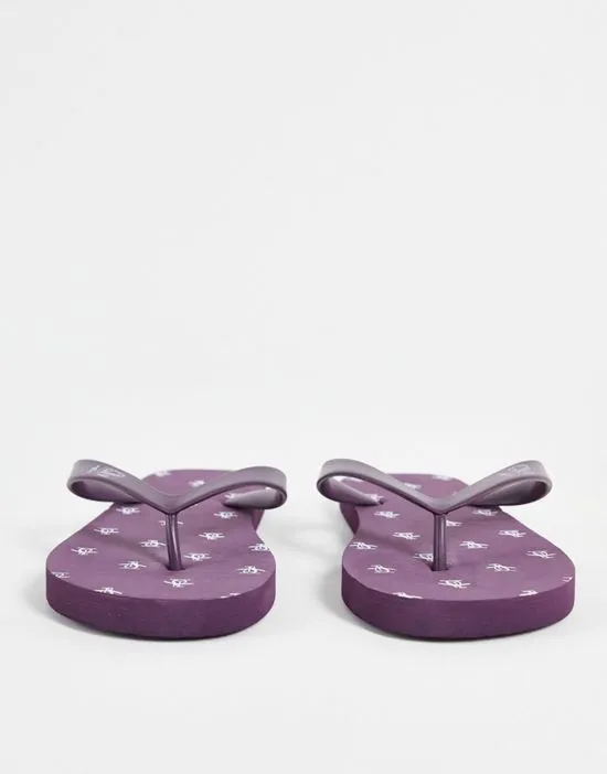 https://images.styletyx.com/images/wide-fit-flip-flops-in-plum-original-penguin-1888526_3.webp
