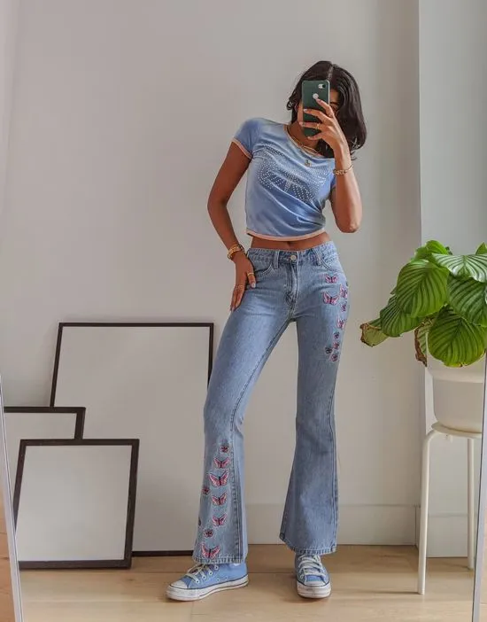 https://images.styletyx.com/images/x-pose-and-repeat-mid-rise-90s-flared-jeans-with-butterfly-appliques-in-blue-labelrail-13286485_1.webp