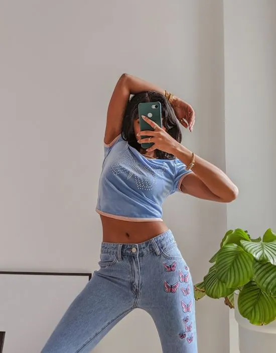 https://images.styletyx.com/images/x-pose-and-repeat-mid-rise-90s-flared-jeans-with-butterfly-appliques-in-blue-labelrail-13286485_4.webp