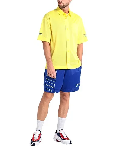 https://images.styletyx.com/images/yellow-techno-fabric-rxp-polo-shirt-reebok-1225884374_2.webp